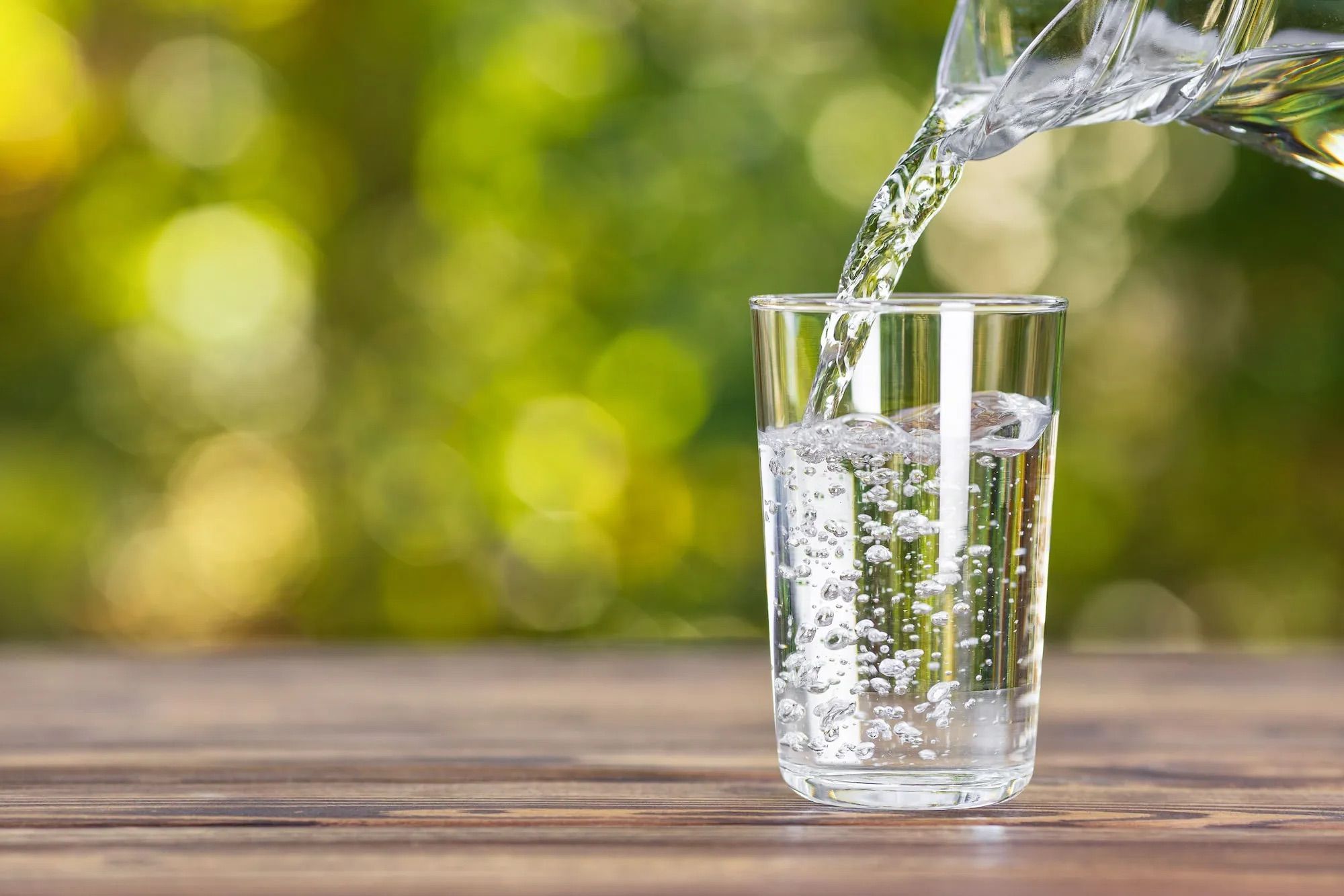 Clear glass of filtered water for sourdough bread hydration