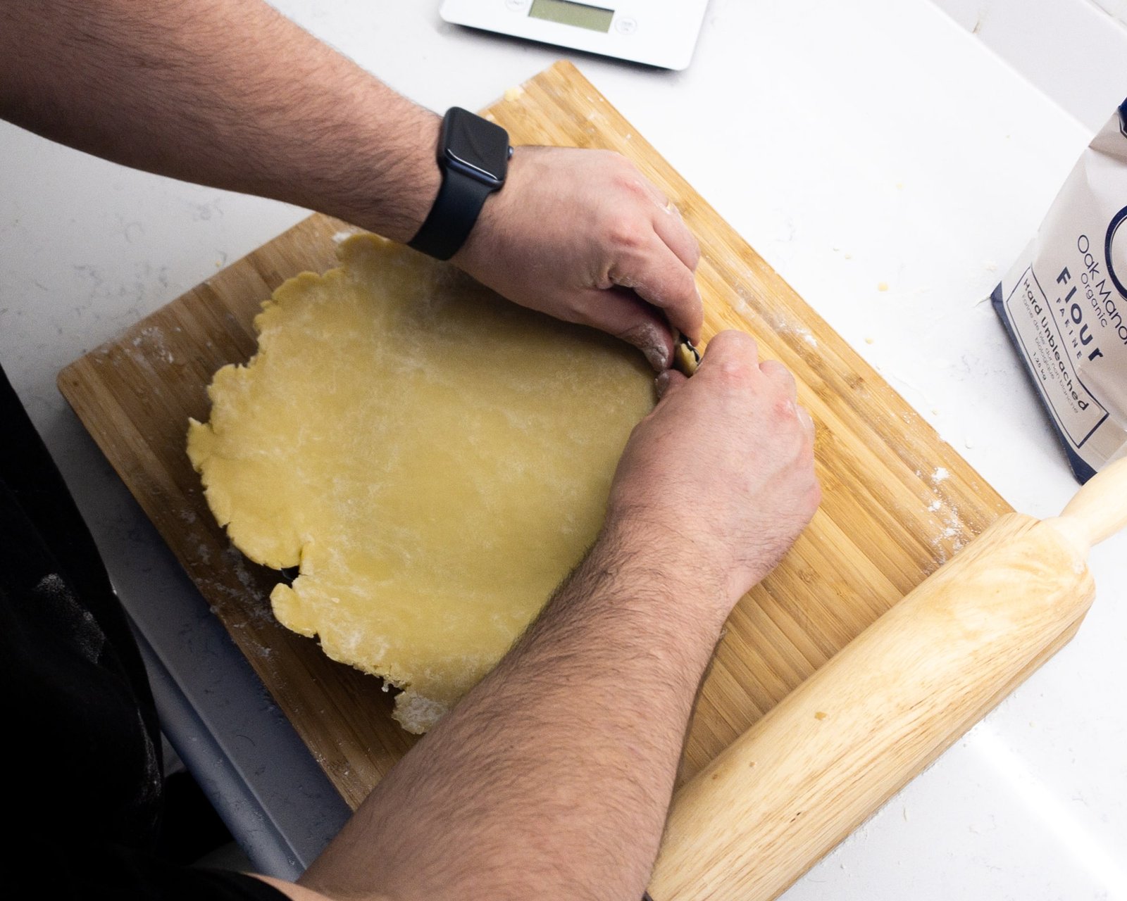 Pastry being pressed into a tart tin