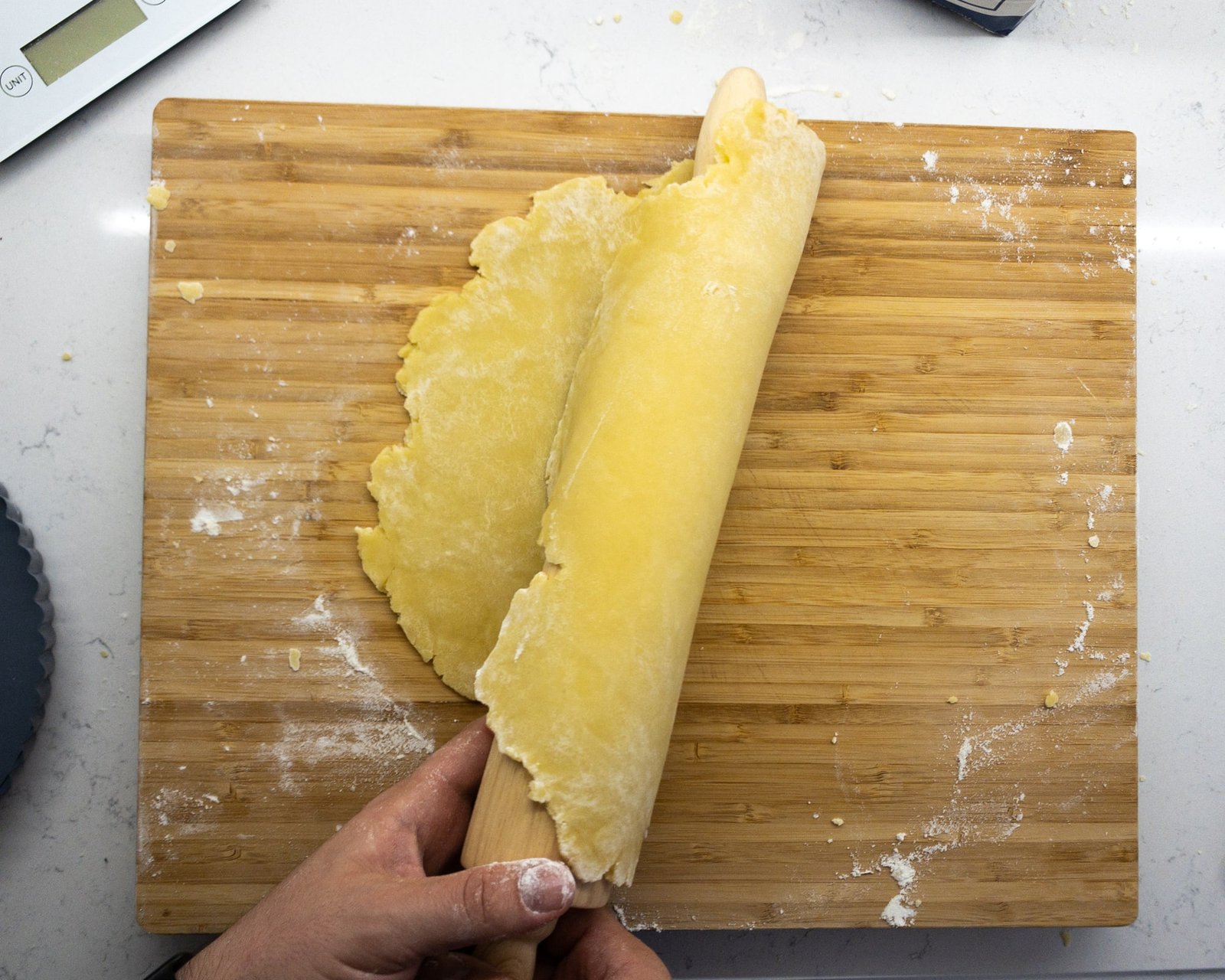 Rolled pastry flipped onto a rolling pin for lifting