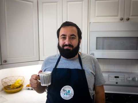 Max drinking coffee in the kitchen